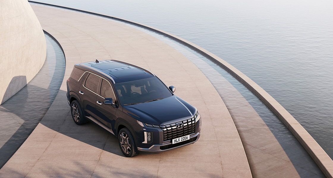 2026 Hyundai Palisade premium 3-row SUV driving on road with spacious family design |Arabwheels.ae